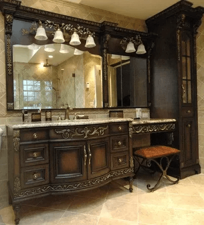 Custom carved dark wood bath vanity with makeup table, crafted by Vanity Fair Baths